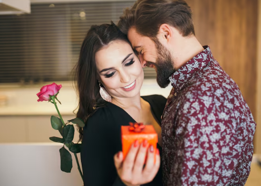 Romantic couple holding a rose and Valentine’s Day gift at home in Singapore