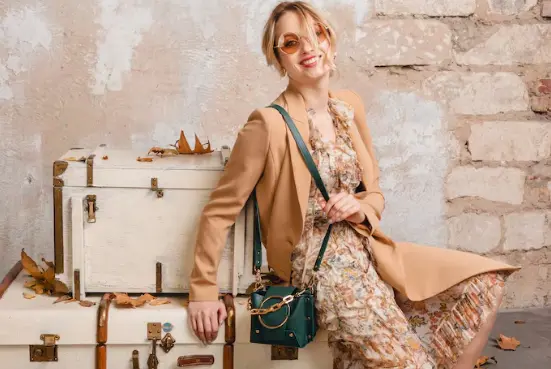 Woman wearing elegant designer dress and luxury handbag showcasing stylish fashion trends from FARFETCH Hong Kong