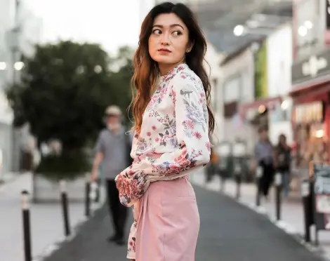 Woman wearing elegant floral designer outfit inspired by luxury street style available on FARFETCH Hong Kong